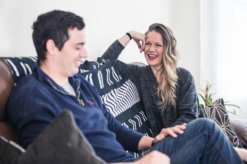 Young adults laughing on a couch at a rehab facility