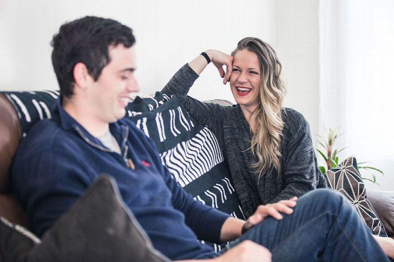 Young adults laughing on a couch at a rehab facility